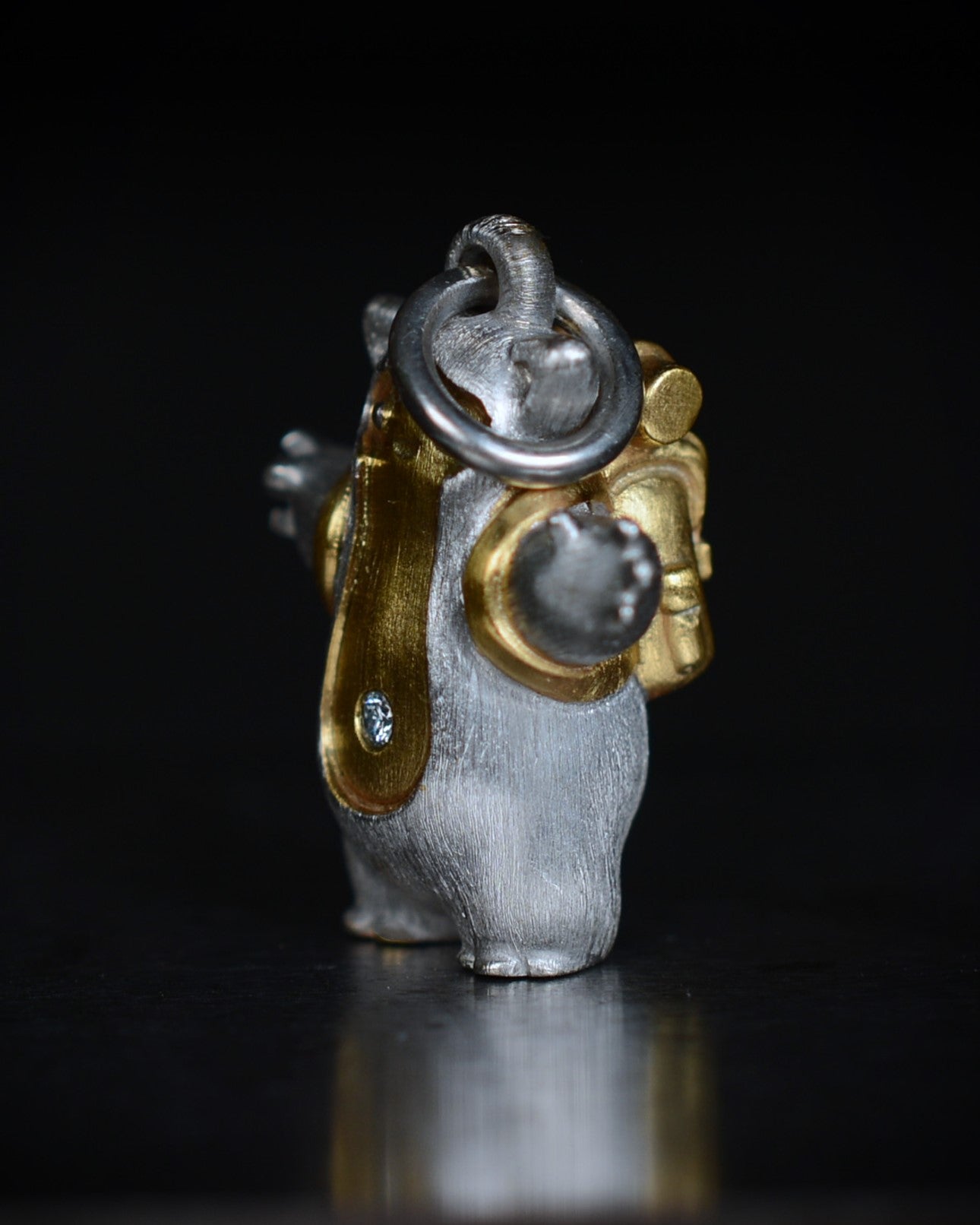 Fox eared, pear shaped, backpacker Bright Creature with a diamond and parcel gilt.