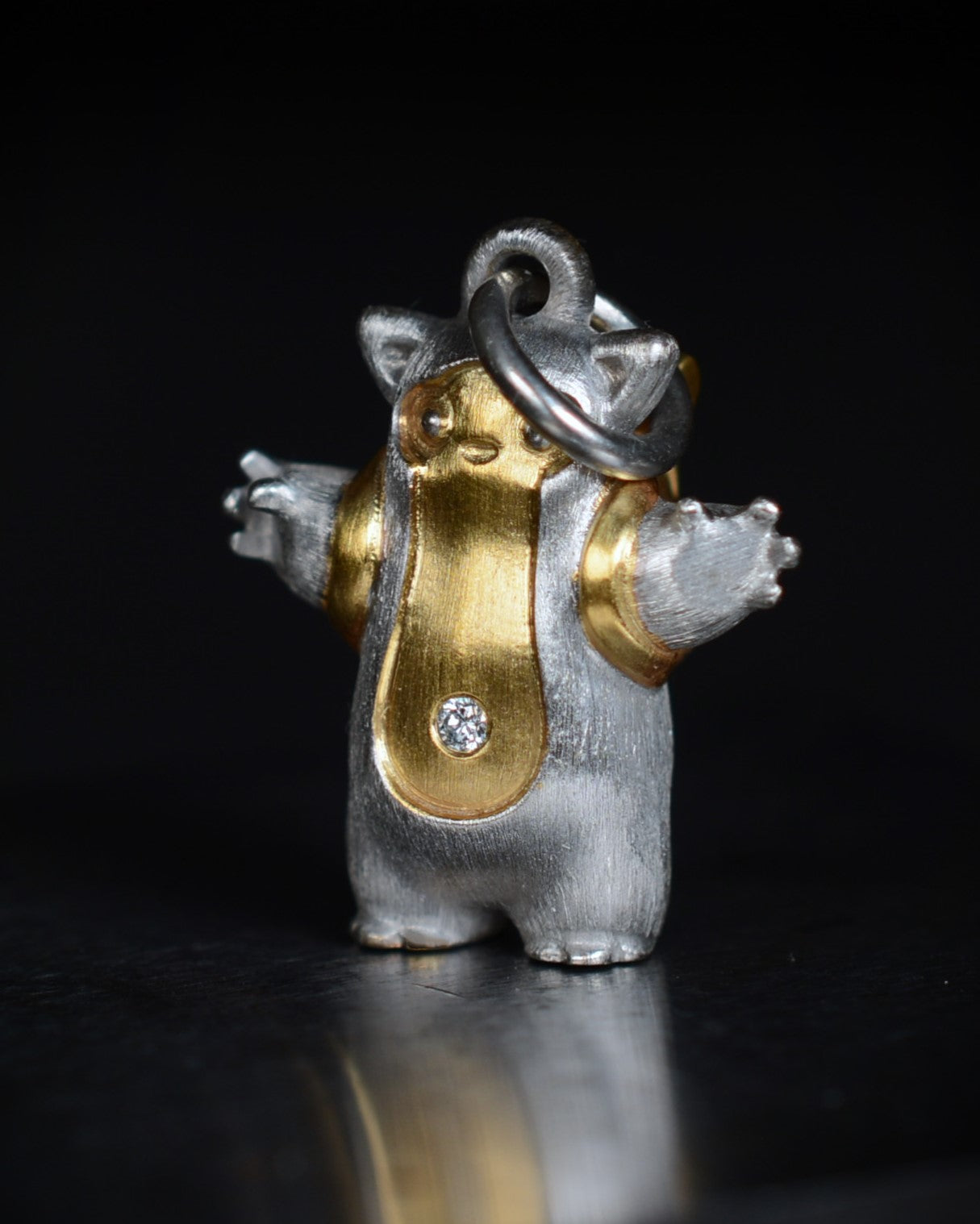 Fox eared, pear shaped, backpacker Bright Creature with a diamond and parcel gilt.