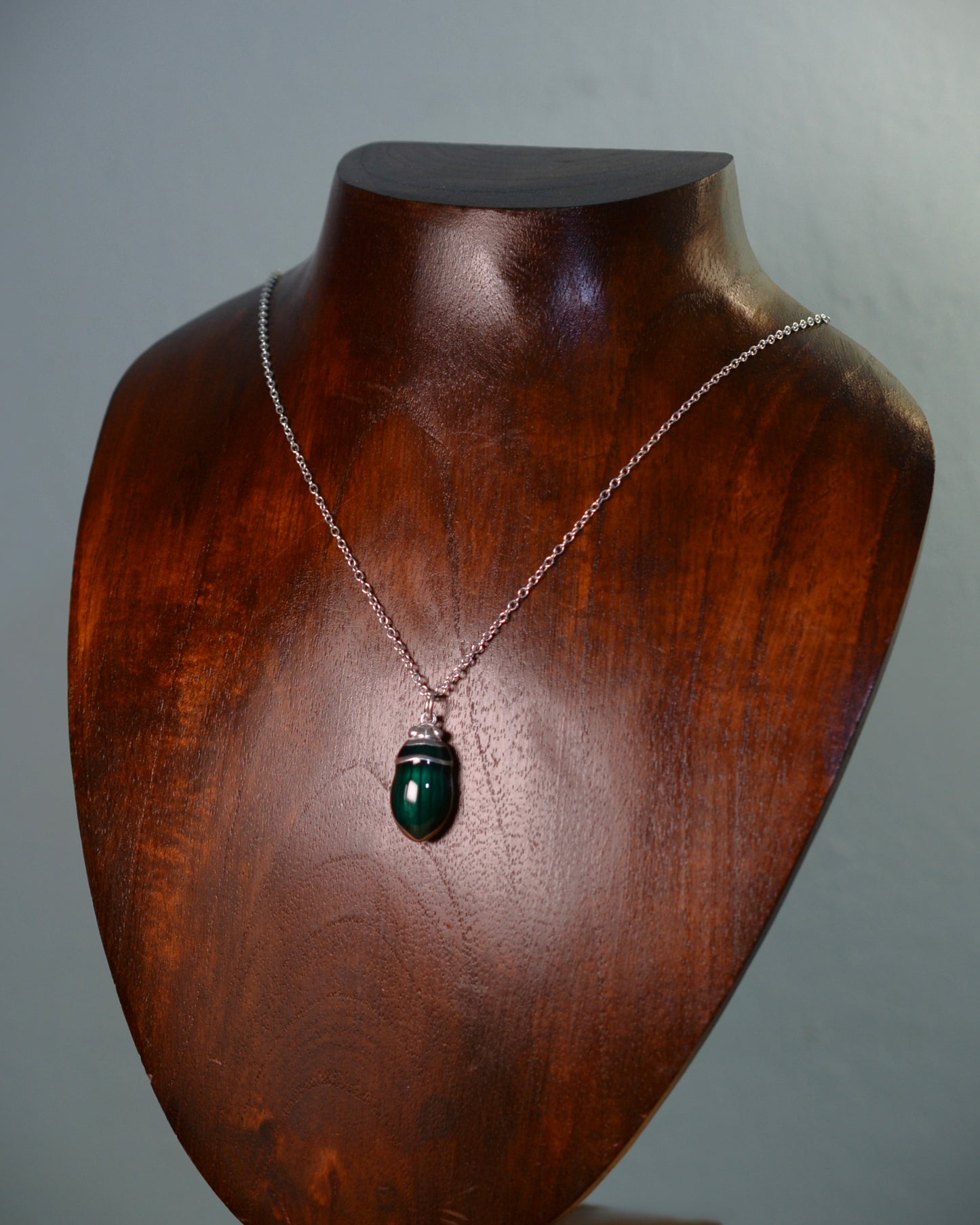 Emerald green beetle pendant. Satin finished silver diving beetle necklace.