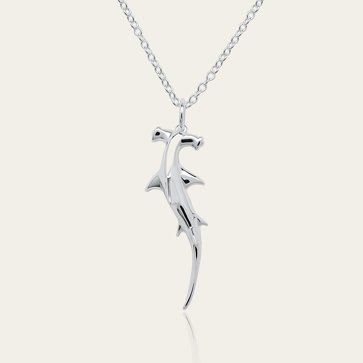 Hammerhead Shark necklace. Made from highly polished, tarnish resistant silver, hung on a solid silver chain. © Adrian Ashley