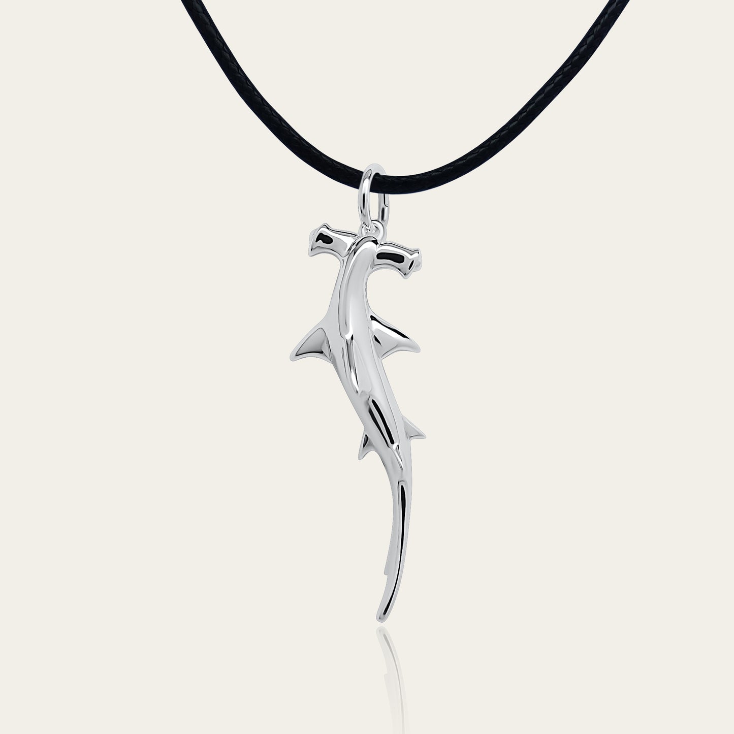 Hammerhead Shark necklace. Made from highly polished, tarnish resistant silver, strung on a strong cord. © Adrian Ashley