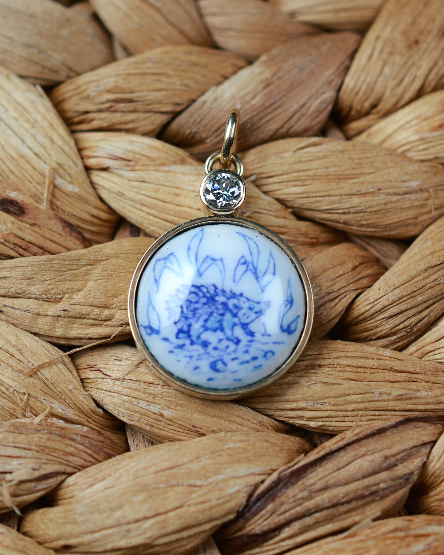 Enamelled gold and silver pendant with a hedgehog motif and natural diamond.