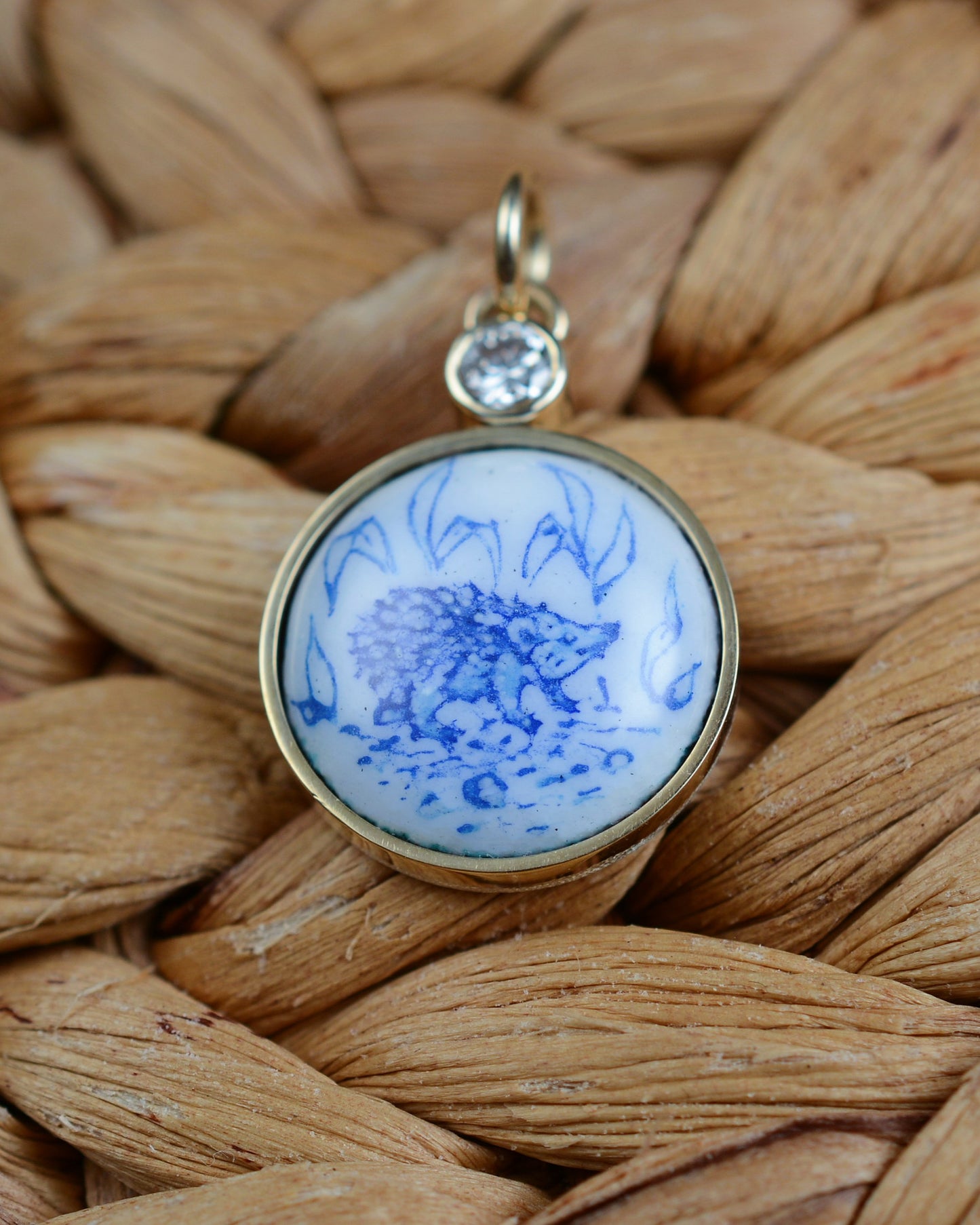 Enamelled gold and silver pendant with a hedgehog motif and natural diamond.