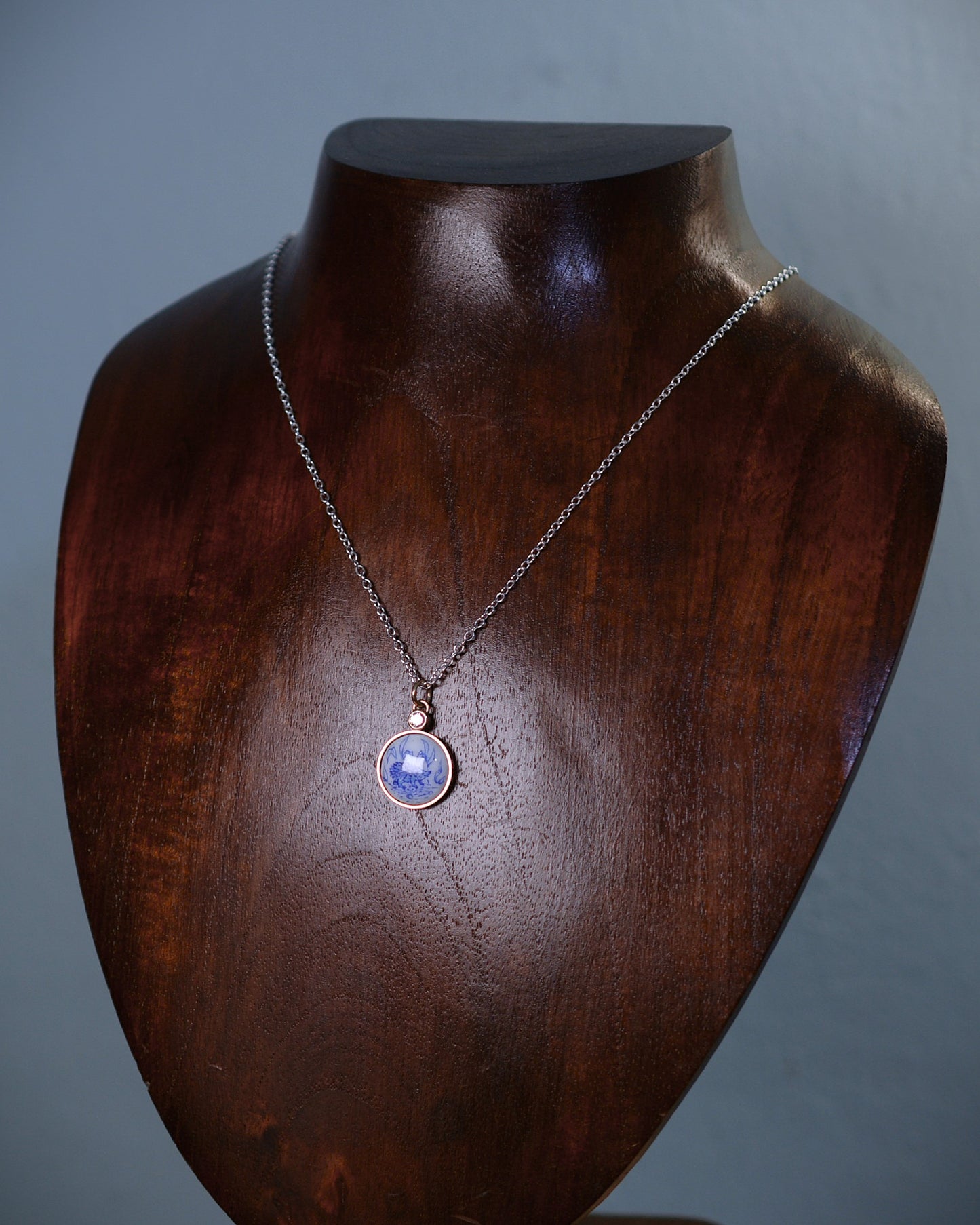 Enamelled gold and silver pendant with a hedgehog motif and natural diamond.