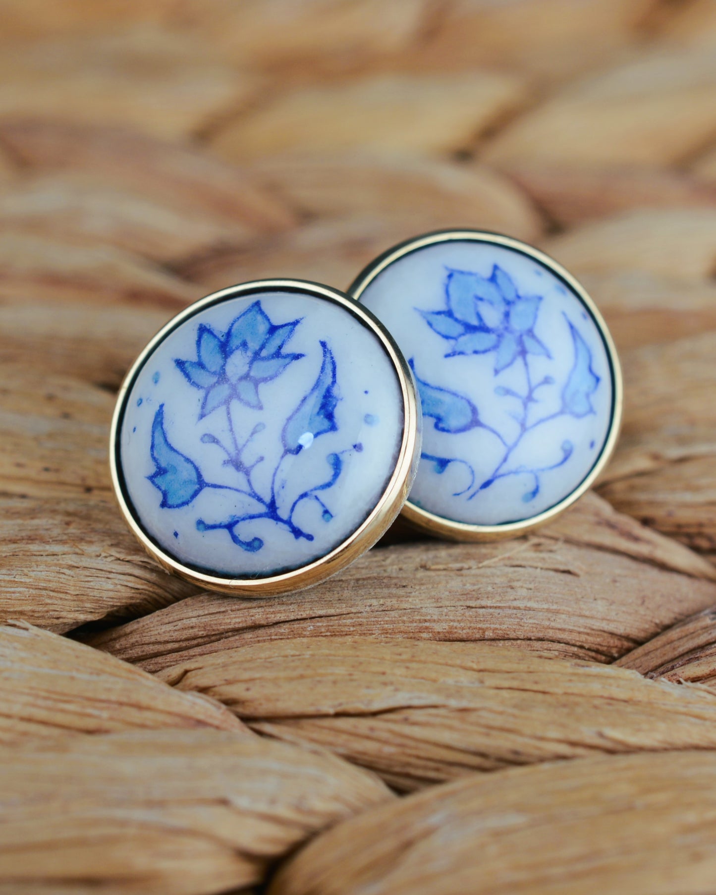 Enamelled gold and silver earrings with a floral motif.