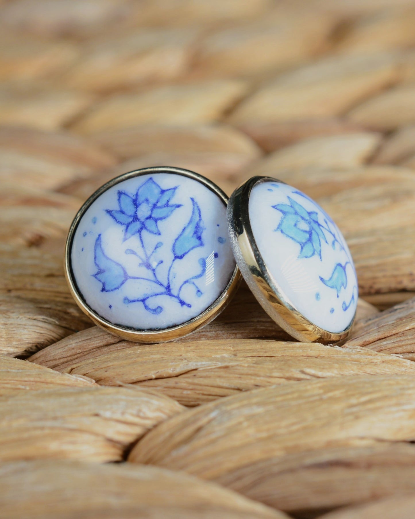 Enamelled gold and silver earrings with a floral motif.