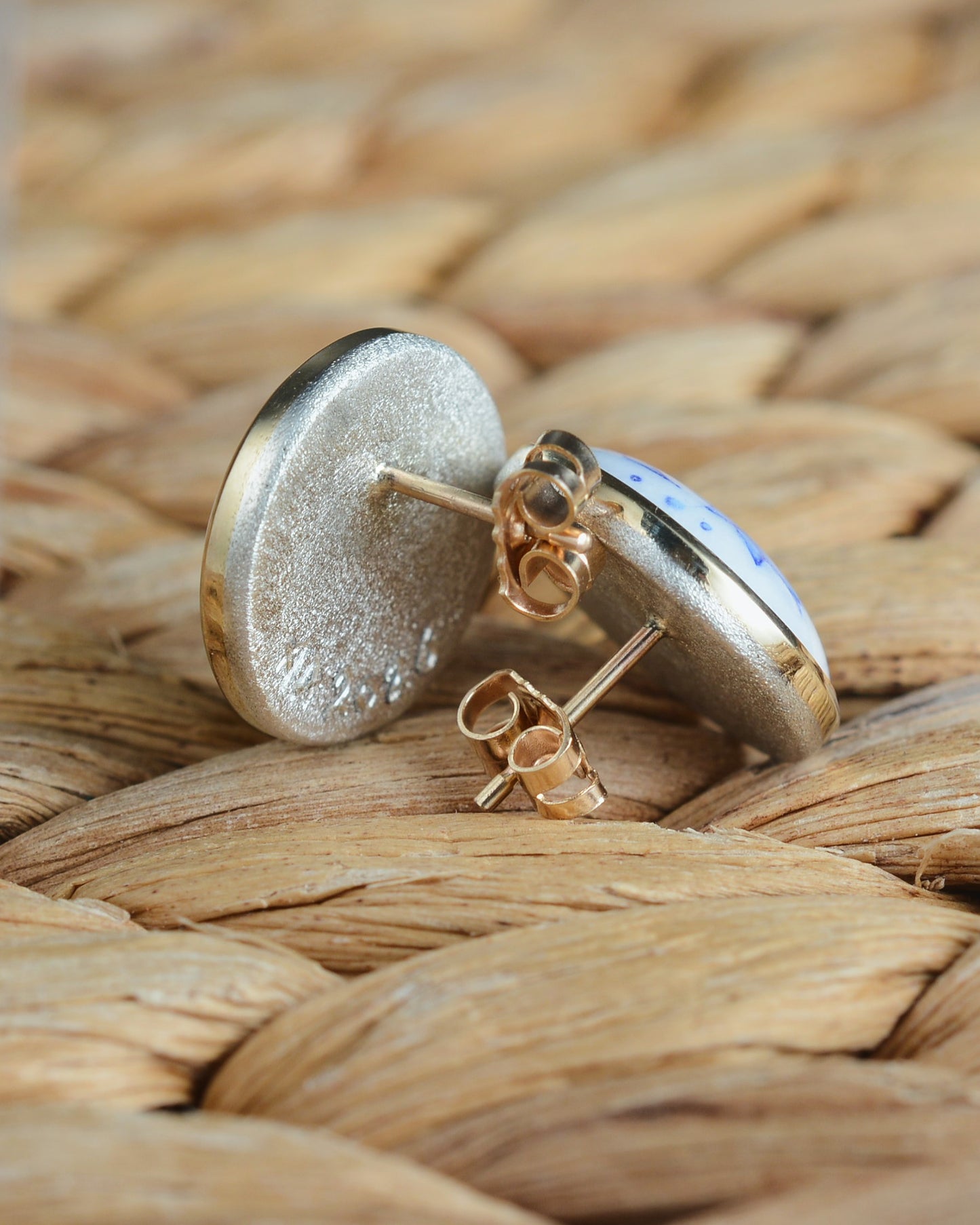 Enamelled gold and silver earrings with a floral motif.