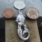 Mermaid necklace. Made from highly polished, tarnish resistant silver, hung on a solid silver chain.  . © Adrian Ashley