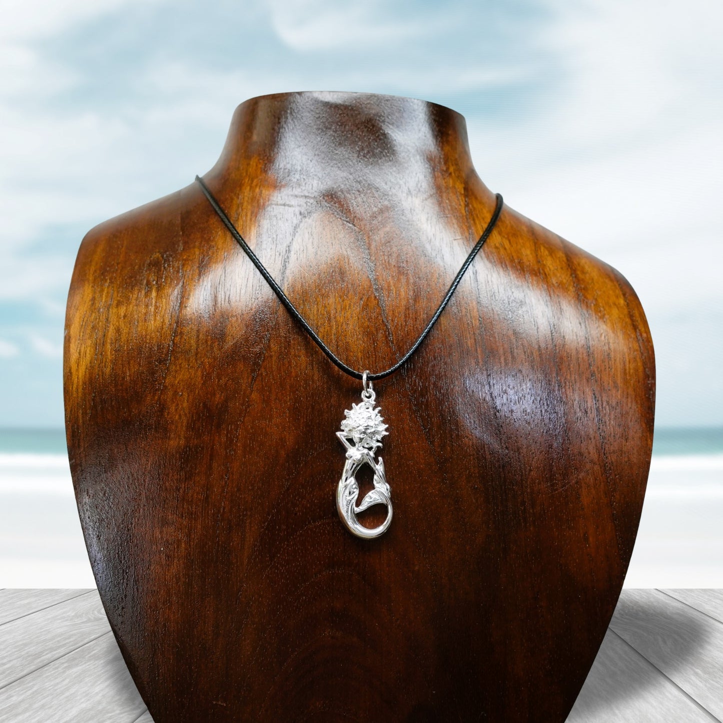 Mermaid necklace. Made from highly polished, tarnish resistant silver, strung on a strong cord. © Adrian Ashley