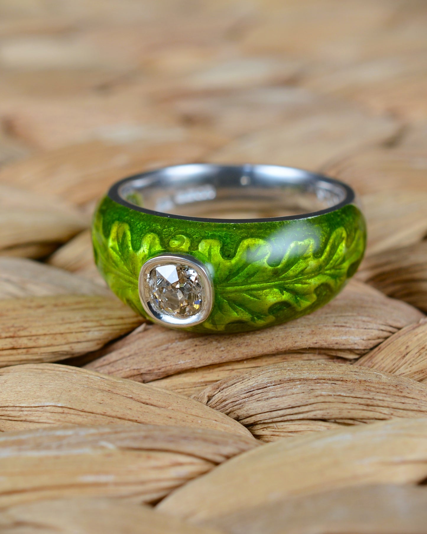 Old cut diamond ring with an enamelled oak leaf motif