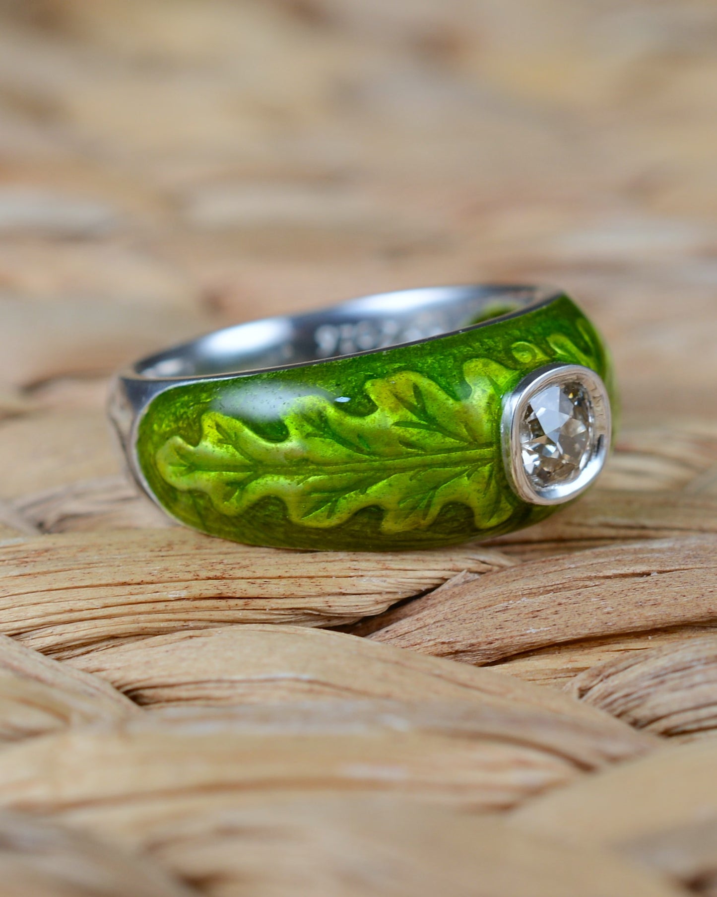 Old cut diamond ring with an enamelled oak leaf motif