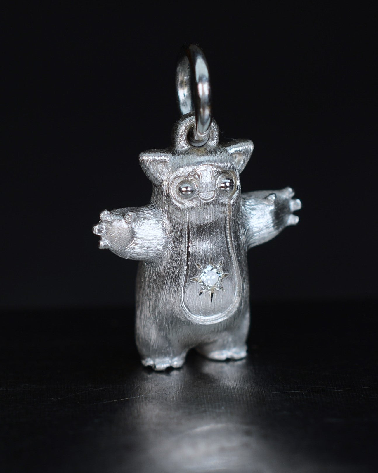 Fox eared pearshape small Bright Creature with a star set natural diamond.