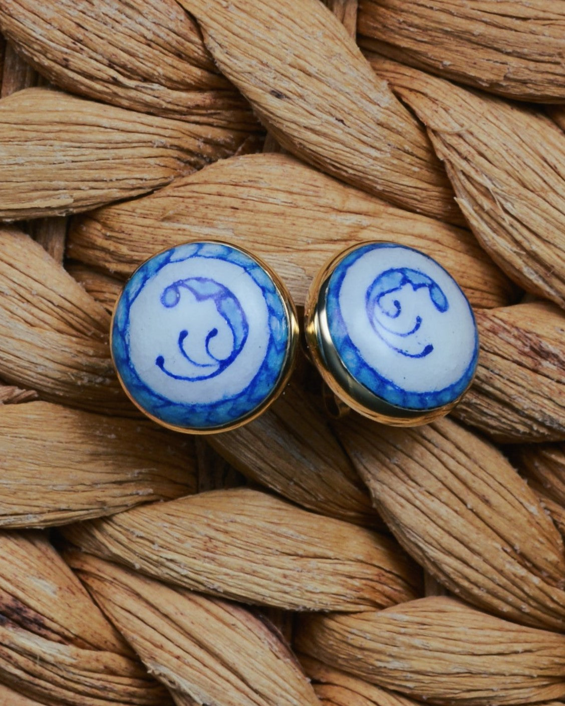 Enamelled gold and silver earrings with a blue motif.