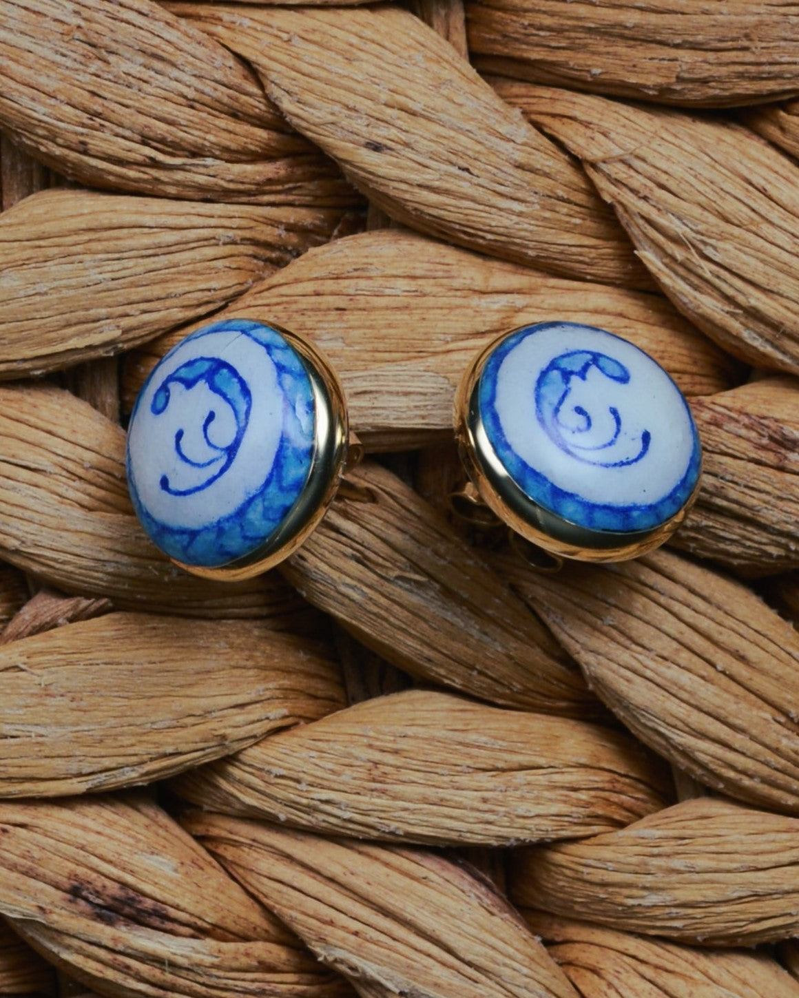 Enamelled gold and silver earrings with a blue motif.