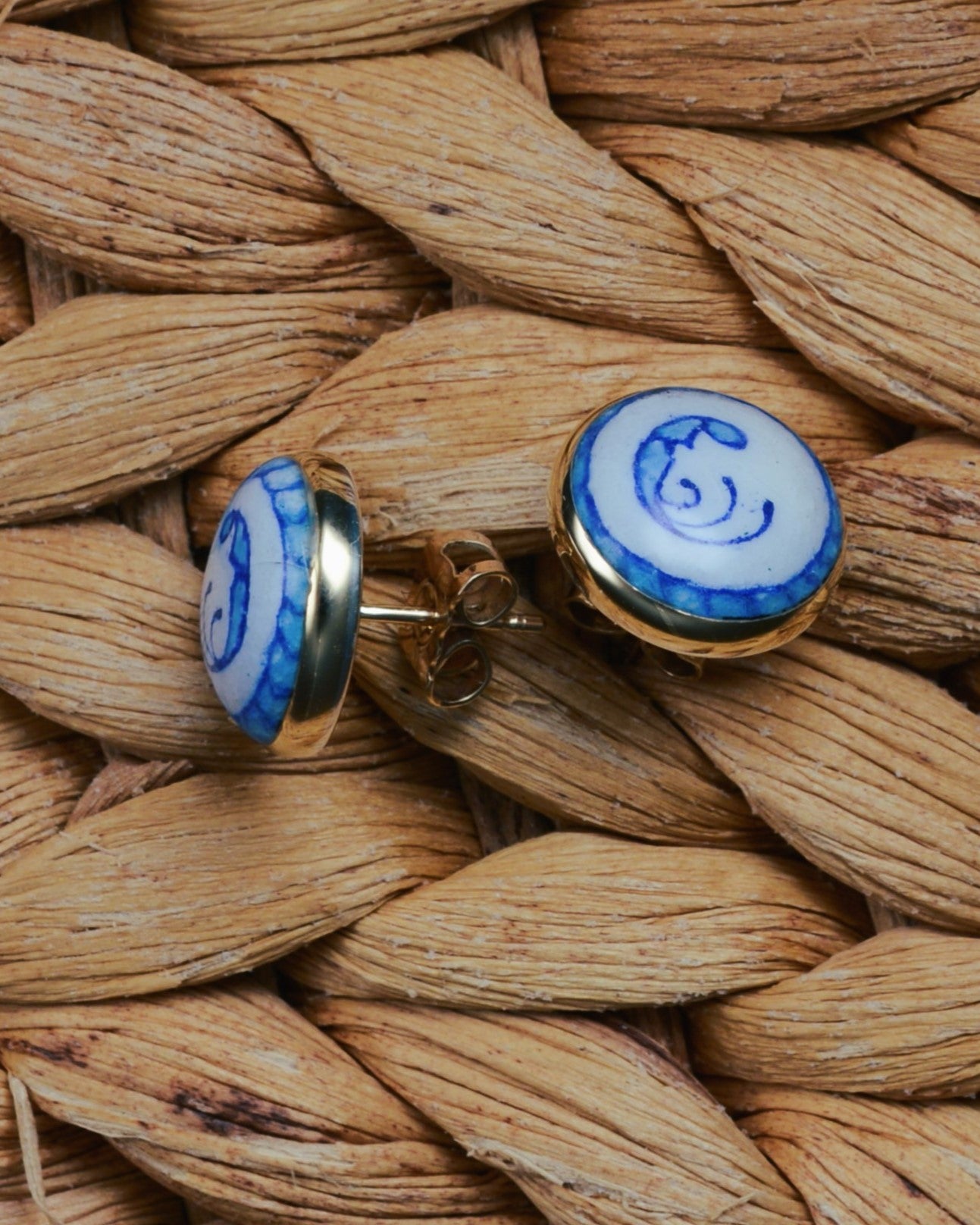 Enamelled gold and silver earrings with a blue motif.
