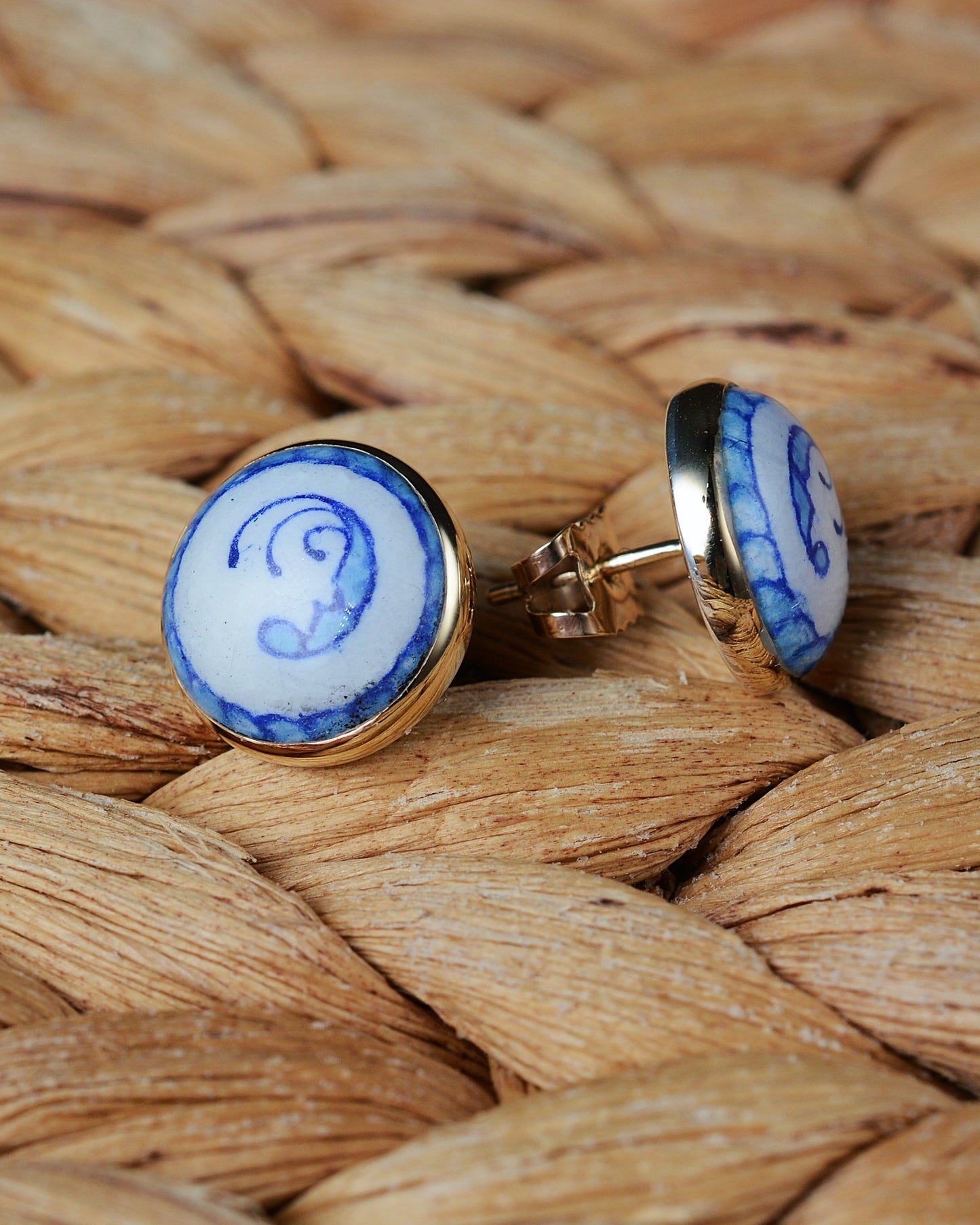Enamelled gold and silver earrings with a blue motif.