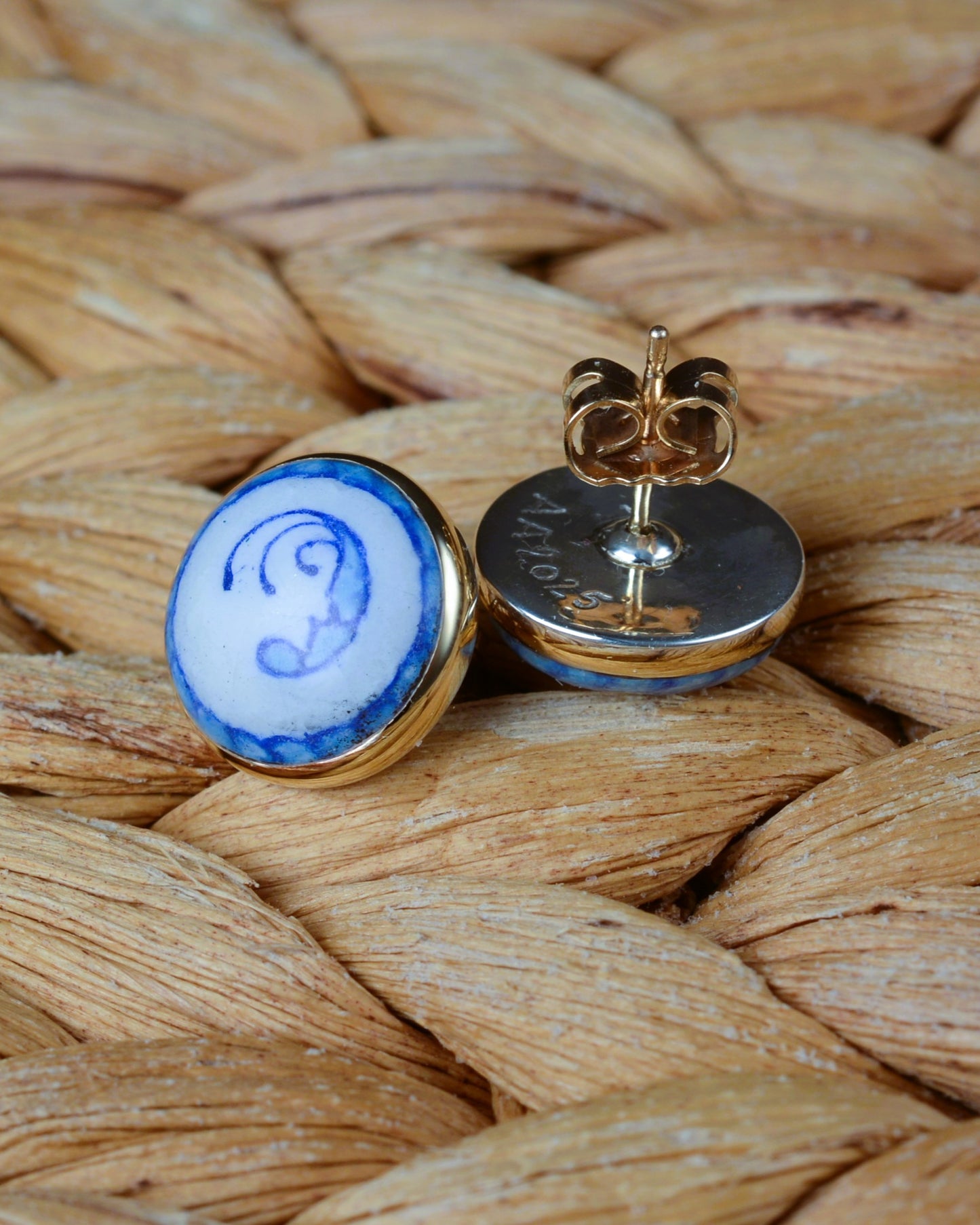 Enamelled gold and silver earrings with a blue motif.