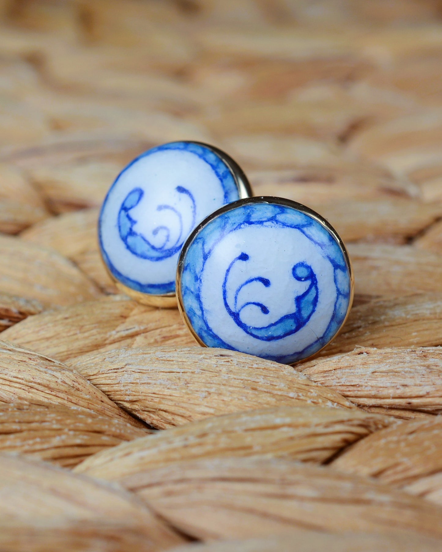 Enamelled gold and silver earrings with a blue motif.