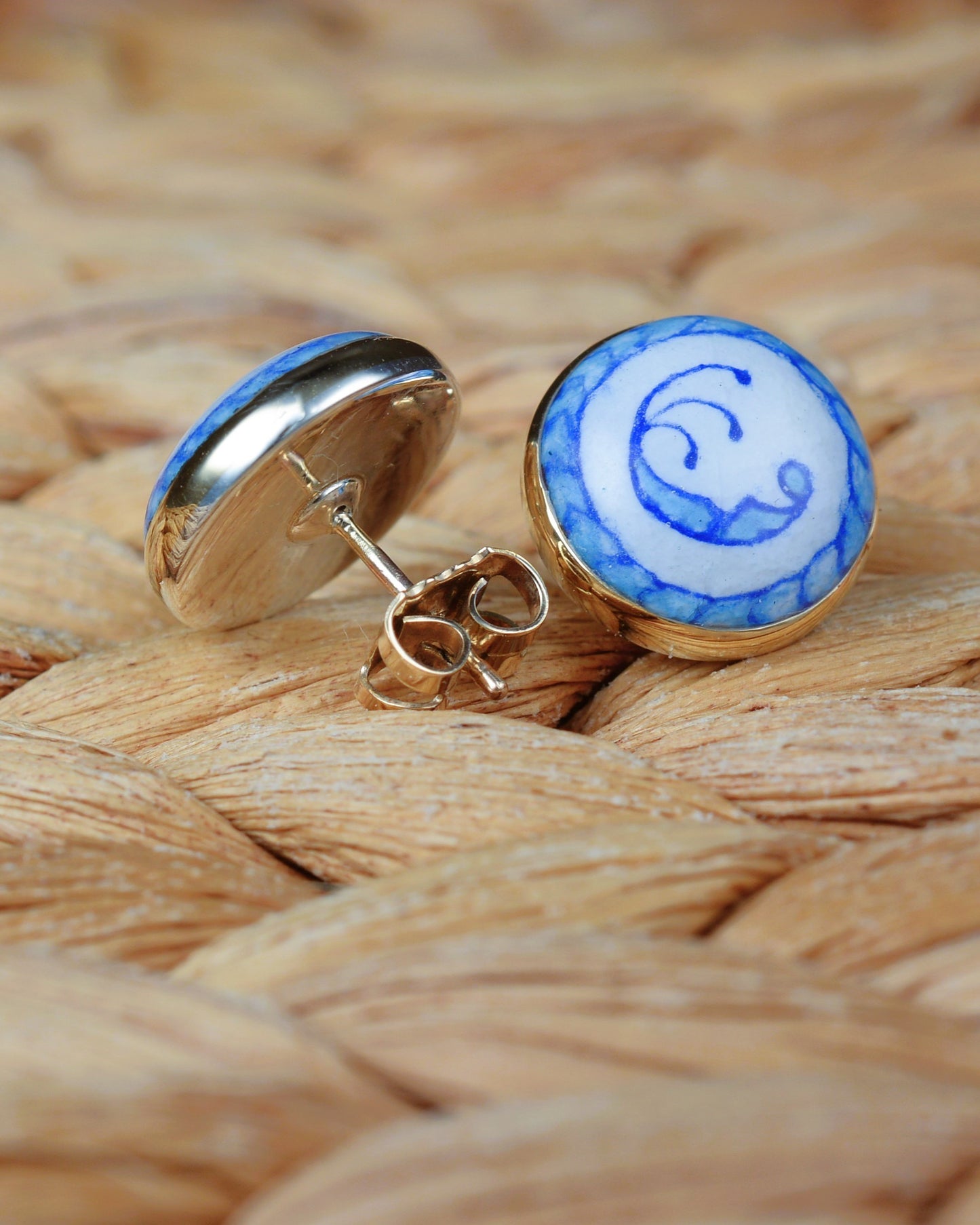 Enamelled gold and silver earrings with a blue motif.