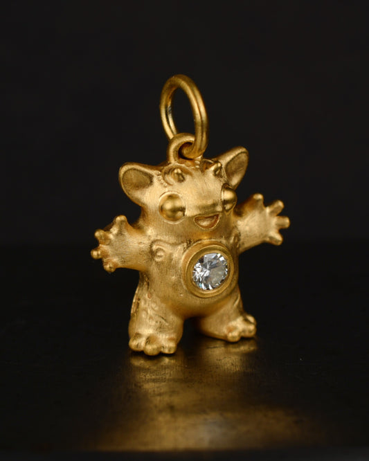 Satin finished vermeil Creature set with a natural diamond.