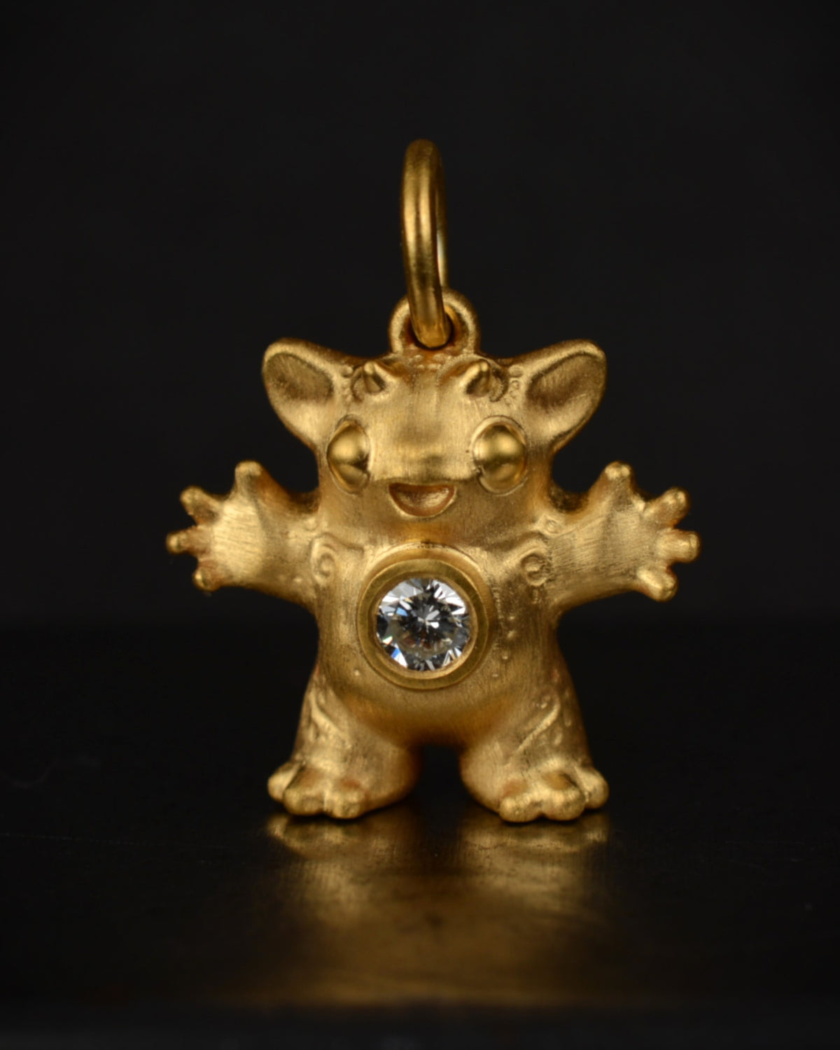Satin finished vermeil Creature set with a natural diamond.