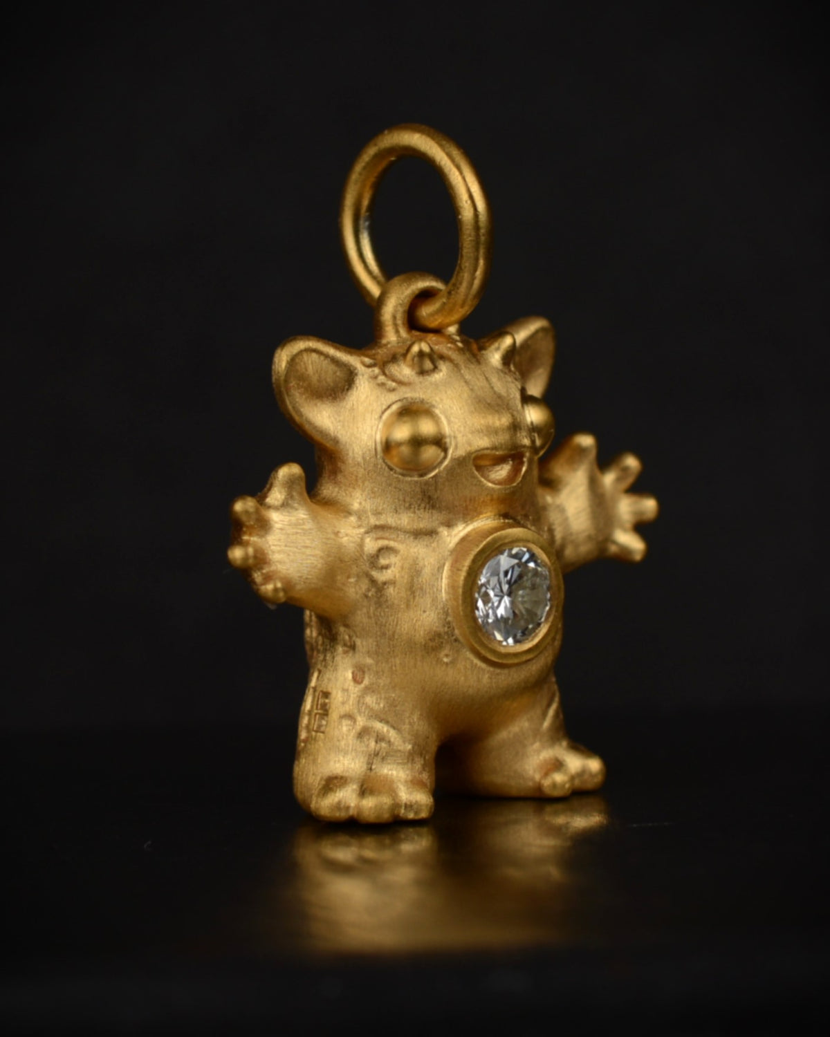 Satin finished vermeil Creature set with a natural diamond.