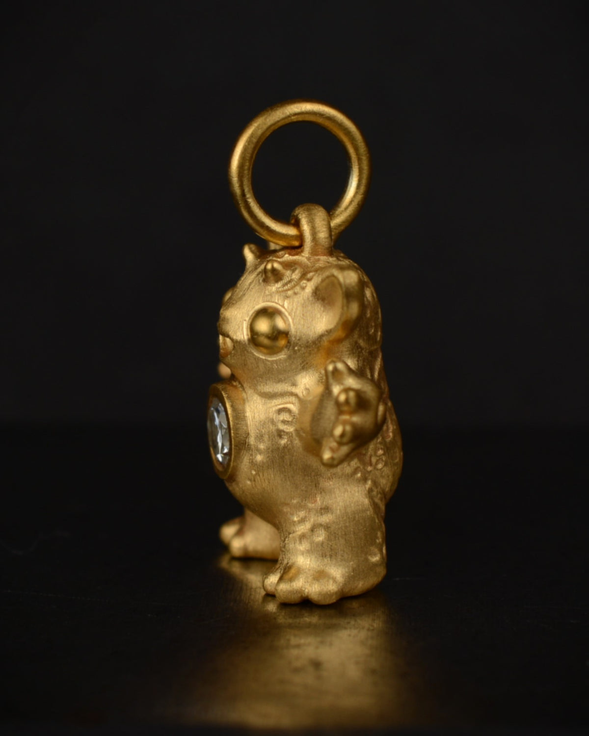 Satin finished vermeil Creature set with a natural diamond.