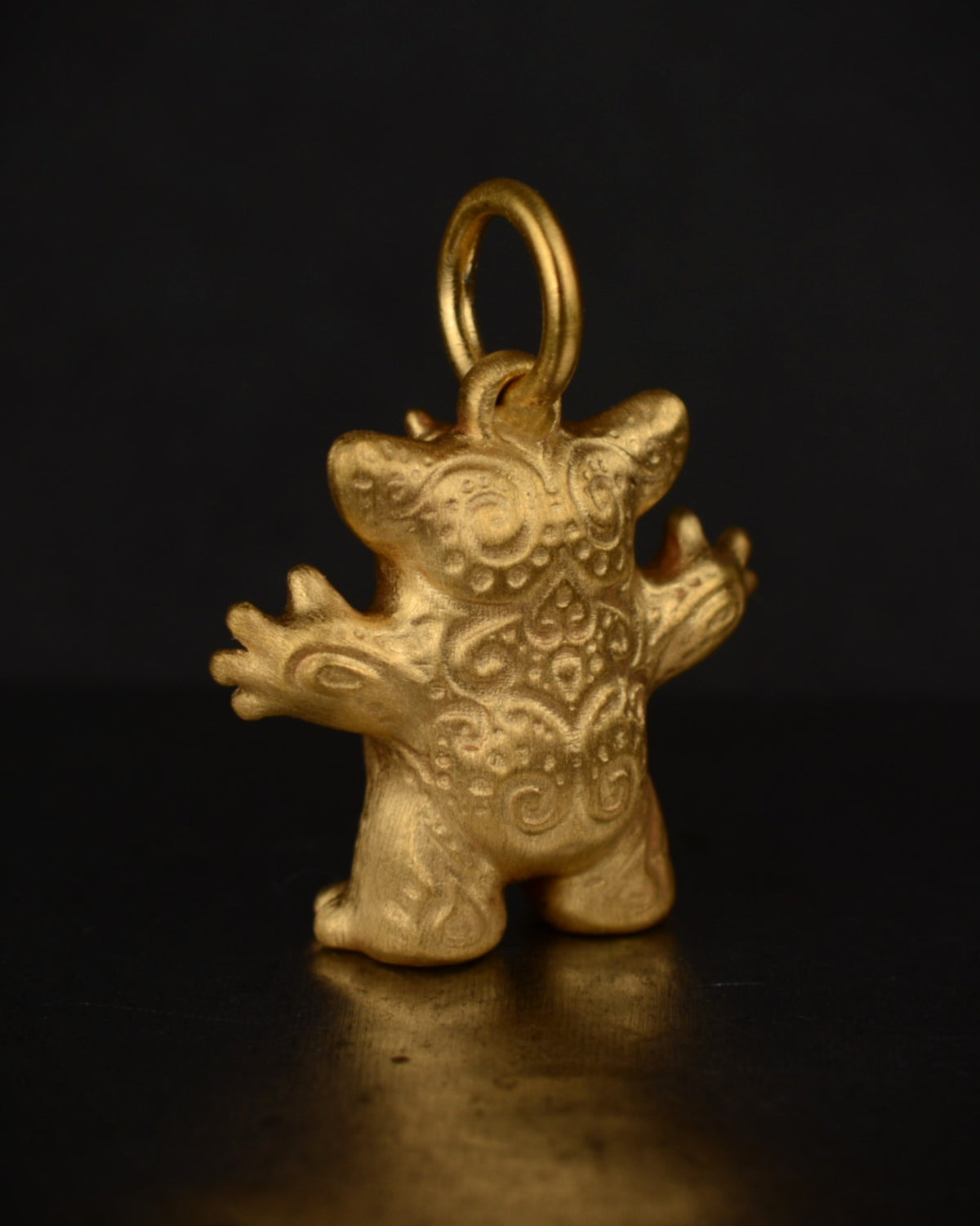 Satin finished vermeil Creature set with a natural diamond.