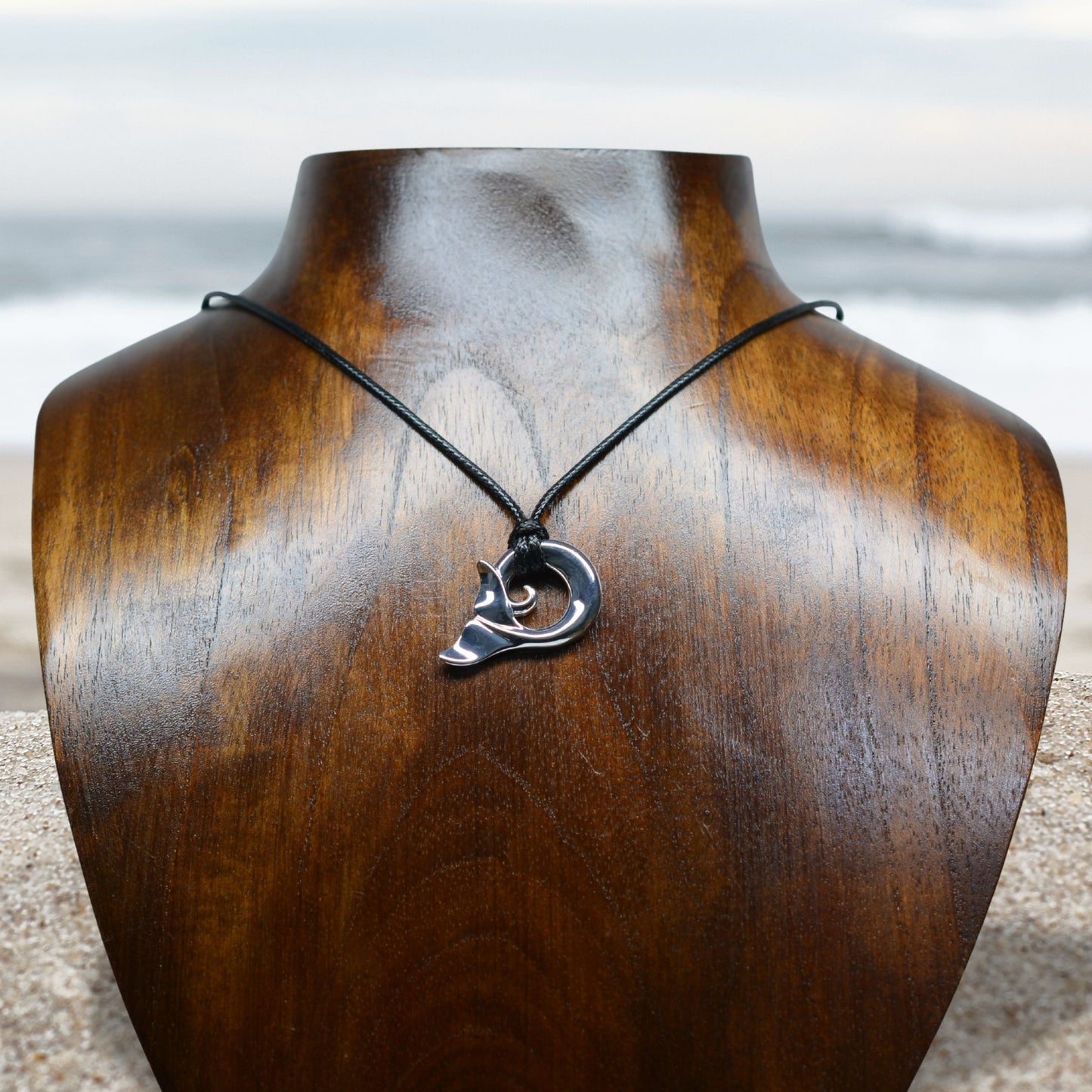 Whale spirit necklace. Made from highly polished, tarnish resistant silver, strung on a strong cord. © Adrian Ashley