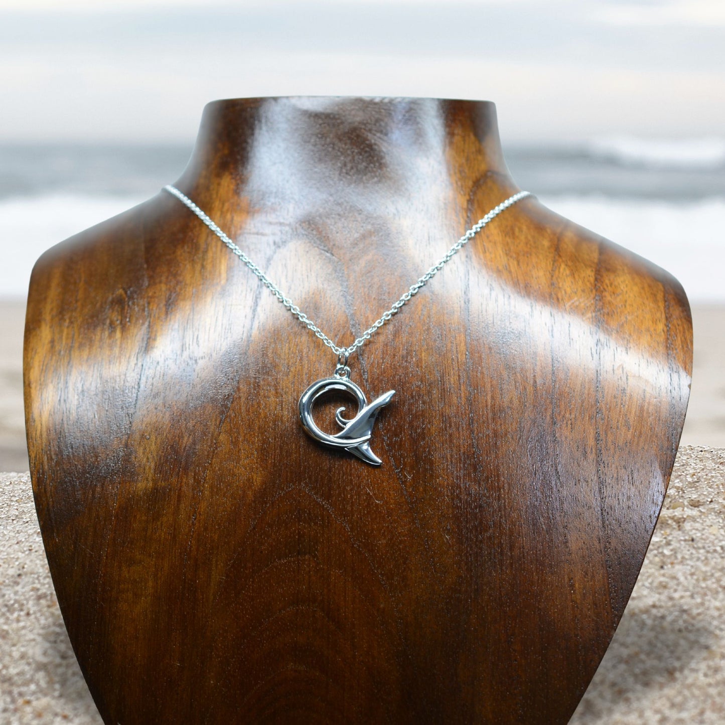 Shark spirit necklace. Made from highly polished, tarnish resistant silver, hung on a solid silver chain. © Adrian Ashley