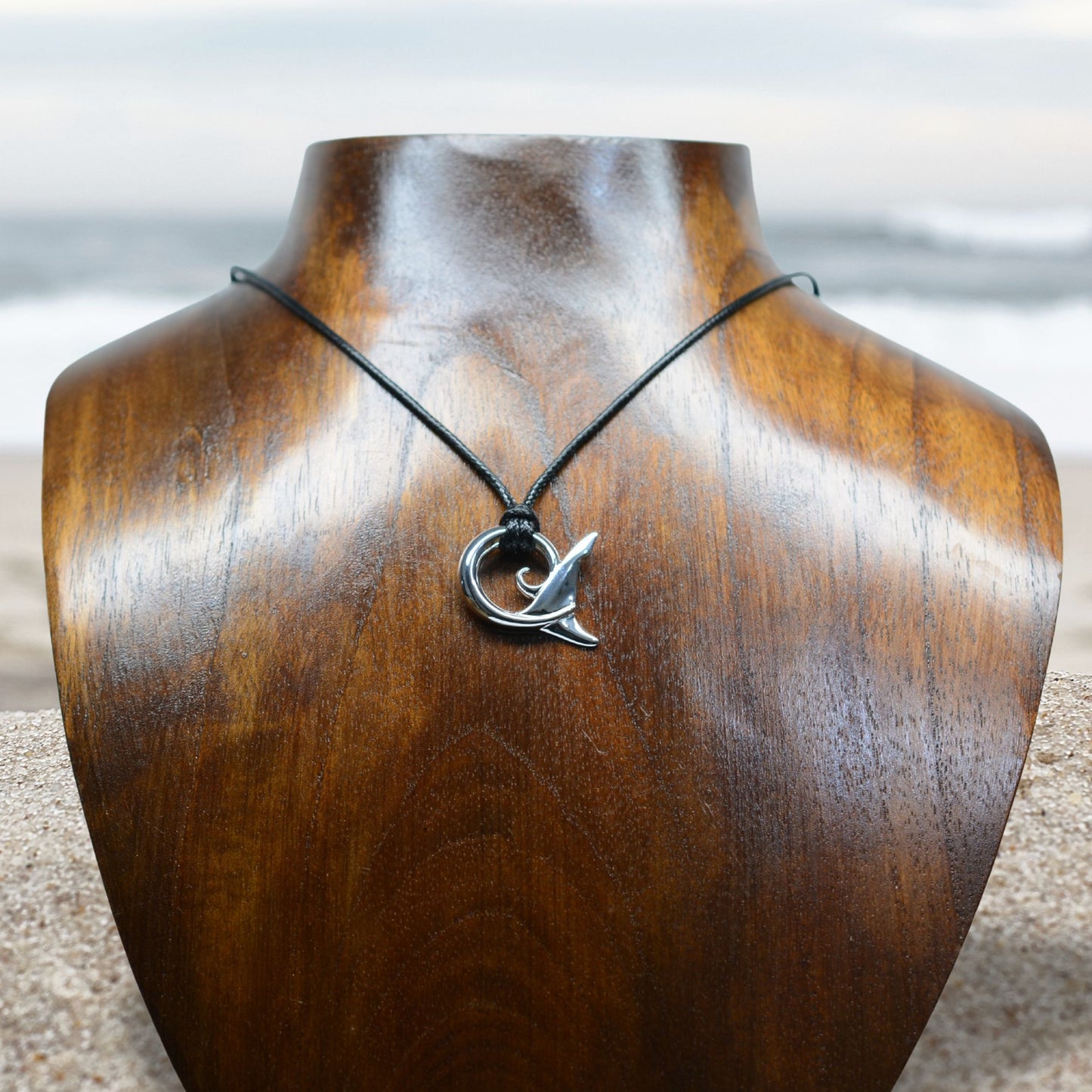 Shark spirit necklace. Made from highly polished, tarnish resistant silver, strung on a strong cord. © Adrian Ashley