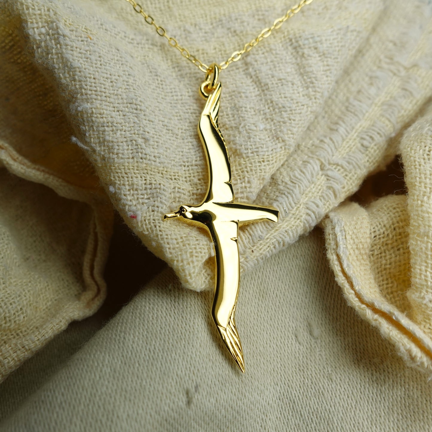 Gold plated silver Albatross pendant and chain. © Adrian Ashley