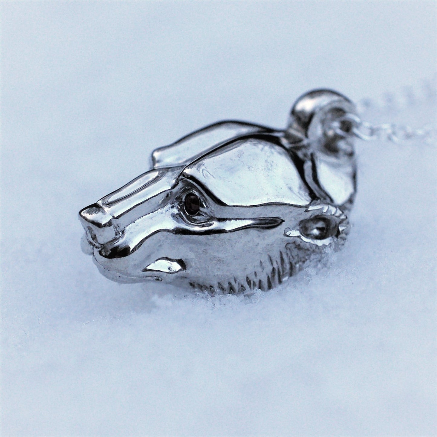 Platinum plated silver polar bear pendant and chain. Greenland ruby eyes. © Adrian Ashley