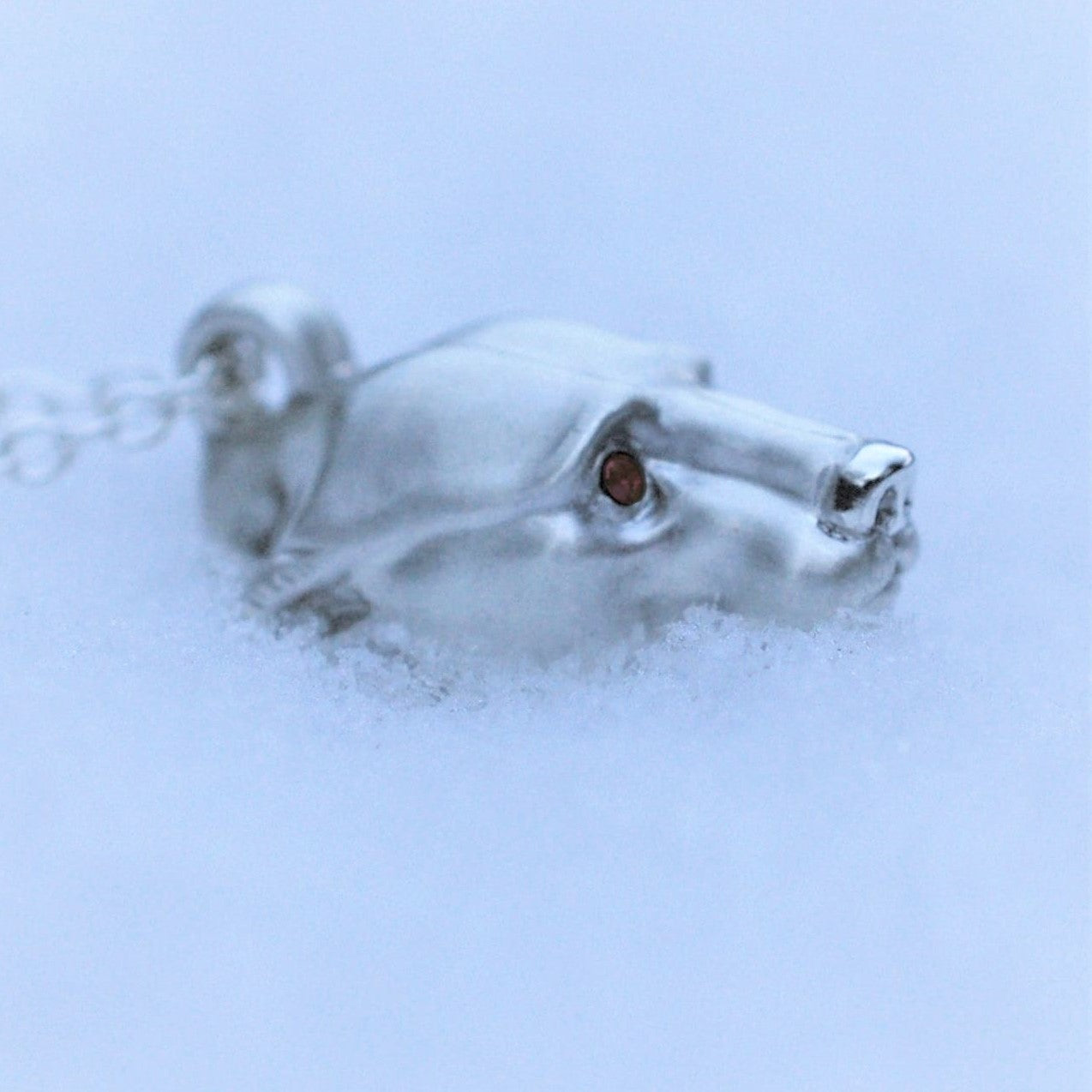 Silver polar bear pendant and chain. Satin finished with a shiny nose and Greenland ruby eyes. © Adrian Ashley