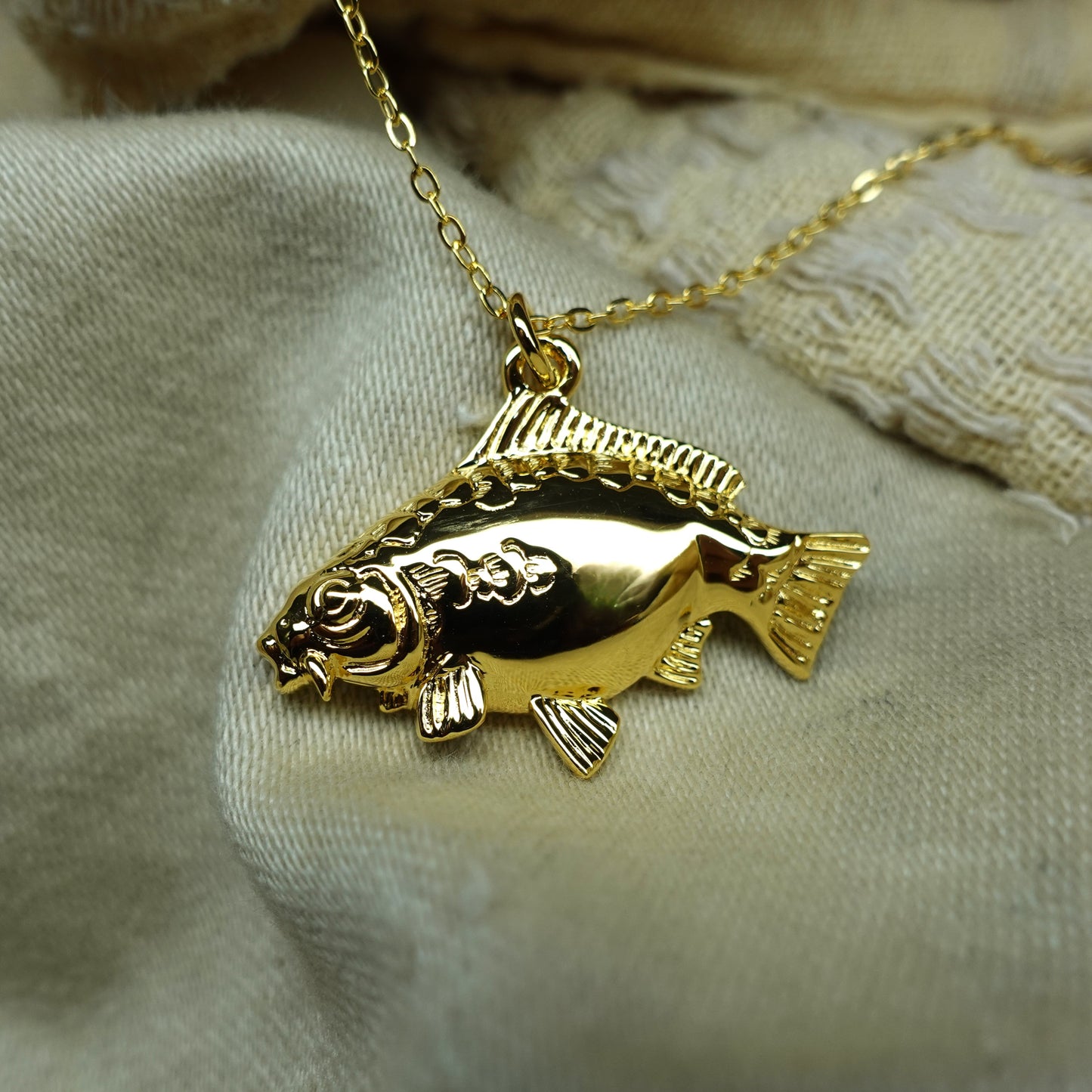 Gold plated silver Mirror Carp pendant and chain. © Adrian Ashley