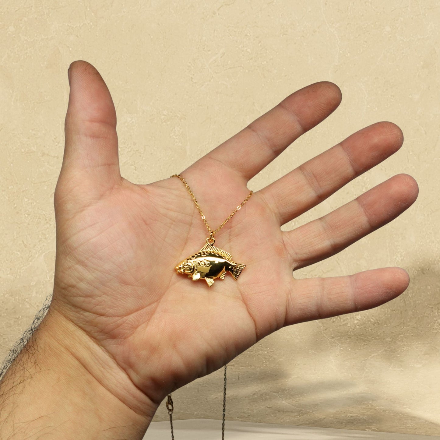 Gold plated silver Mirror Carp pendant and chain. © Adrian Ashley