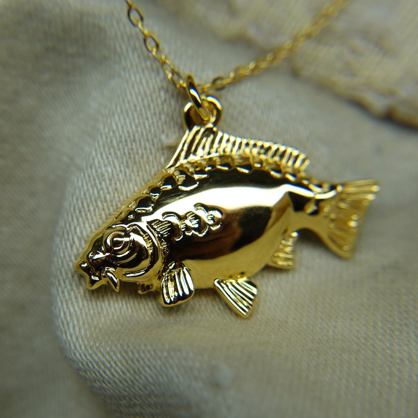 Gold plated silver Mirror Carp pendant and chain. © Adrian Ashley