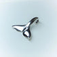 Classic whale tail necklace. Made from highly polished, tarnish resistant silver, hung on a solid silver chain. © Adrian Ashley