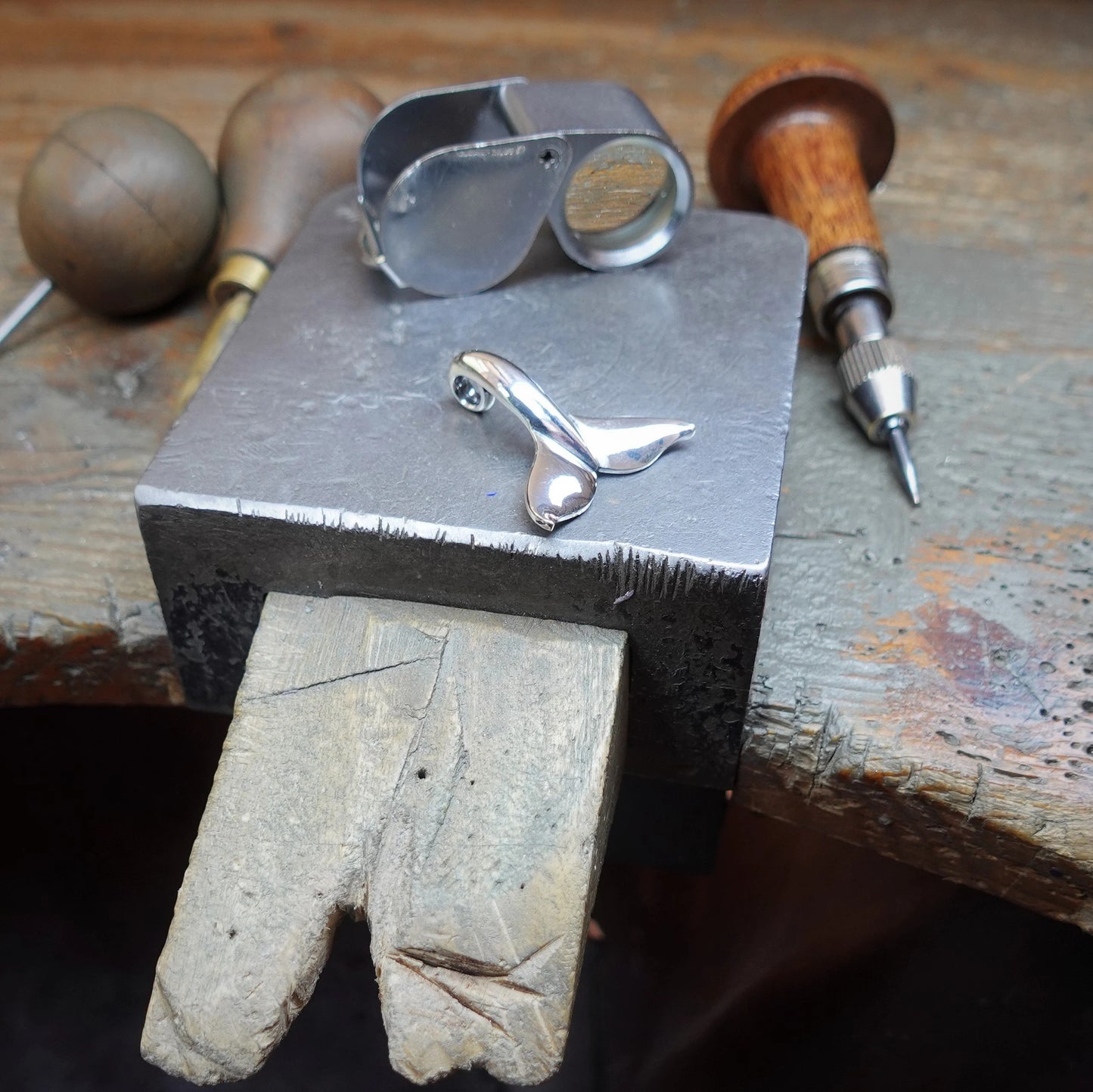 Classic whale tail necklace. Made from highly polished, tarnish resistant silver, strung on a strong cord. © Adrian Ashley