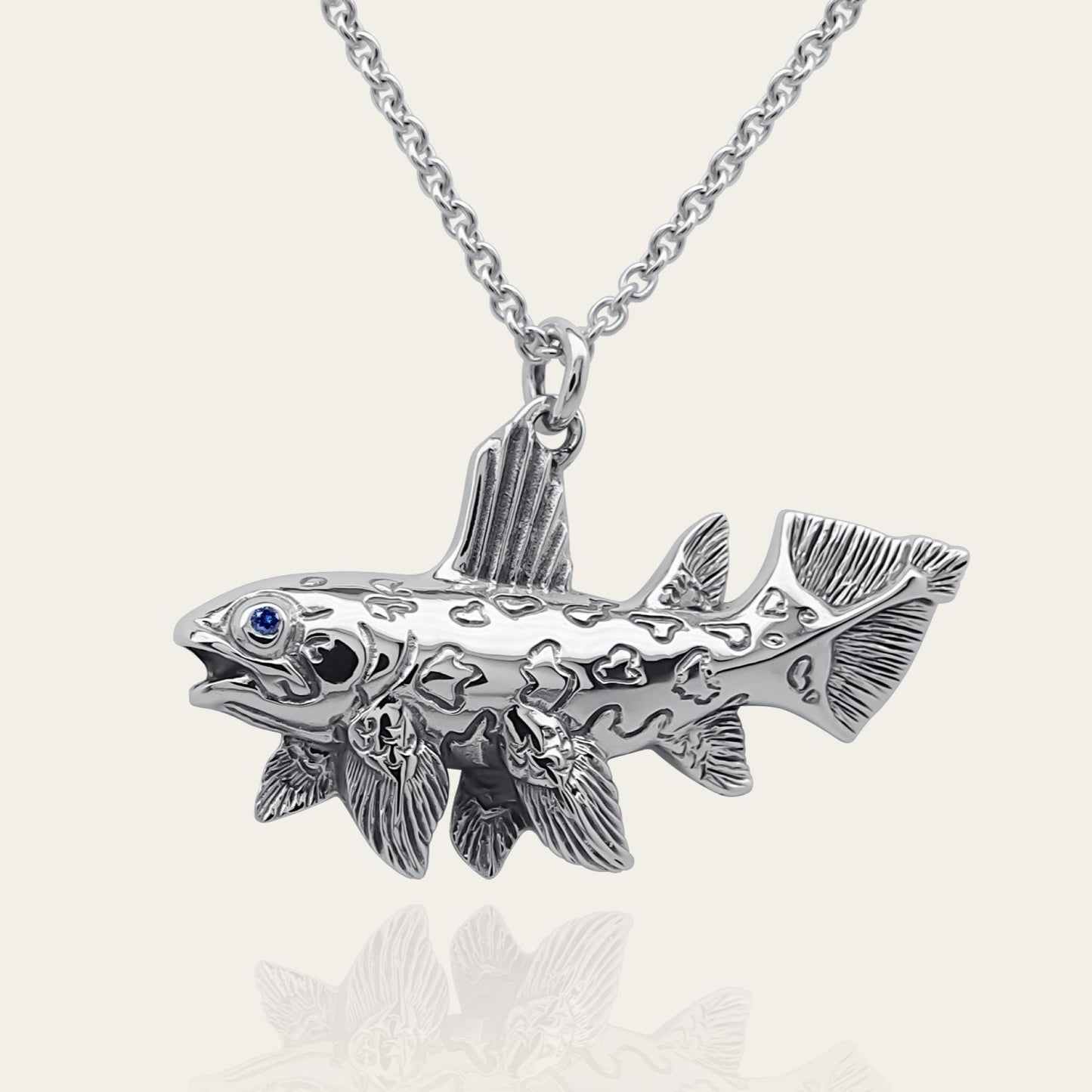 Coelacanth necklace. Made from sterling silver with an antiqued finish, set with a gemstone eye. Prehistoric fish pendant © Adrian Ashley