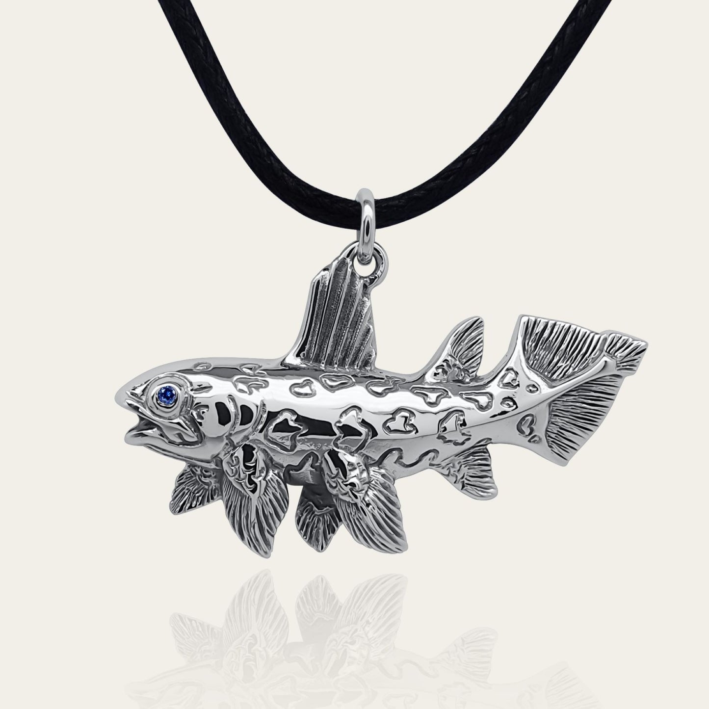 Coelacanth necklace. Made from sterling silver with an antiqued finish, set with a gemstone eye. Prehistoric fish pendant © Adrian Ashley