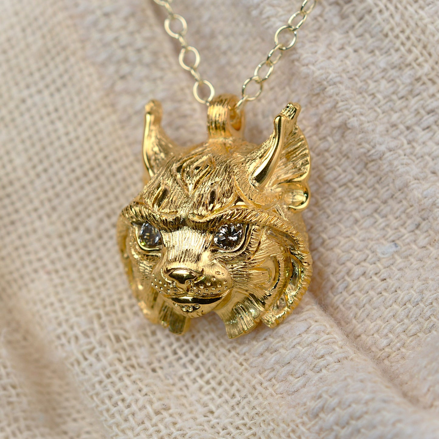Gold lynx head pendant with diamond eyes and a gold chain. *This piece is finished and ready to be shipped* © Adrian Ashley
