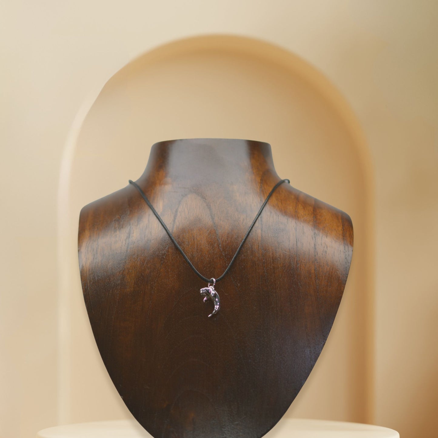 Dugong necklace, Made from highly polished, tarnish resistant silver, strung on a strong cord. © Adrian Ashley