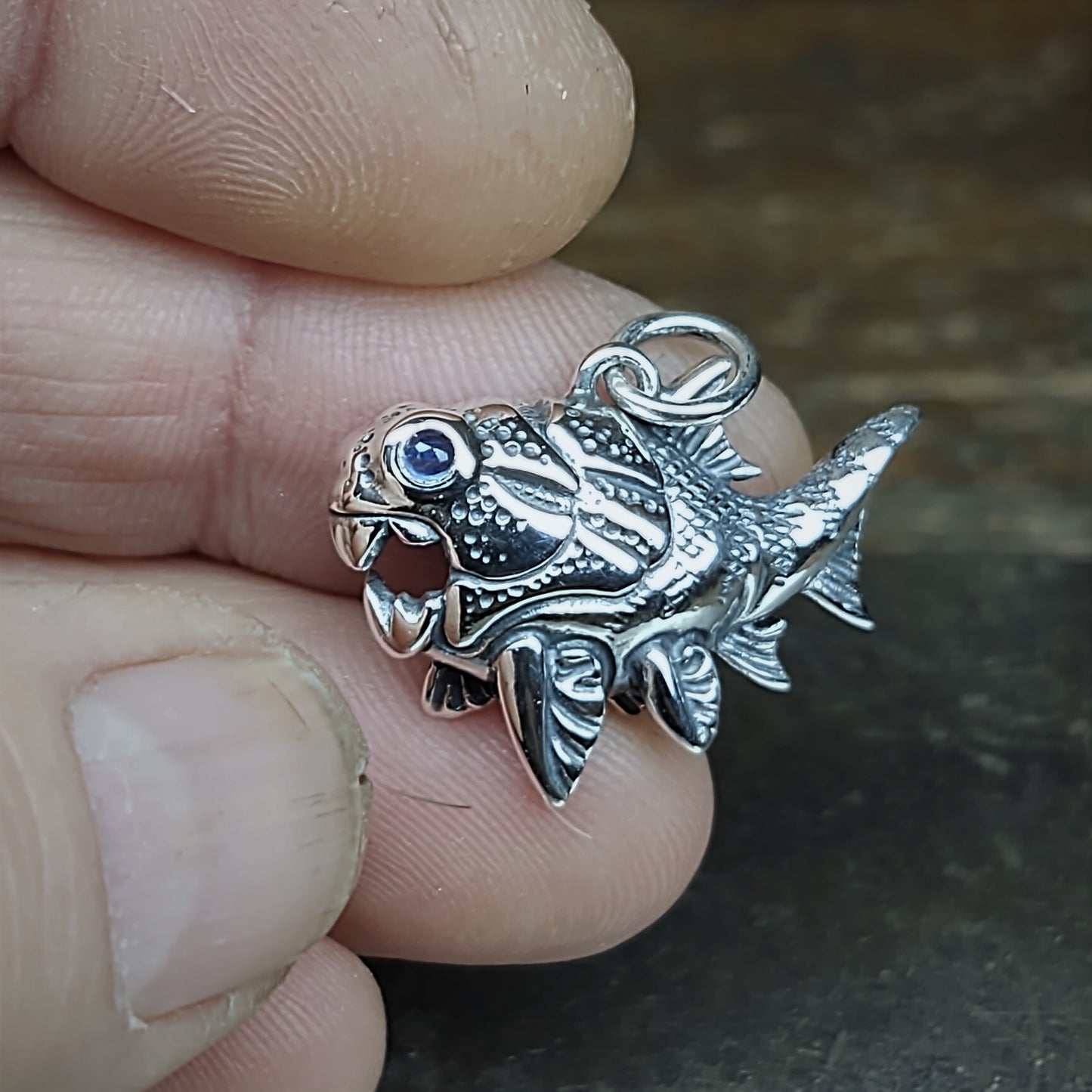 Dunkleosteus necklace. Made from sterling silver with an antiqued finish, set with a gemstone eye. Prehistoric fish pendant © Adrian Ashley