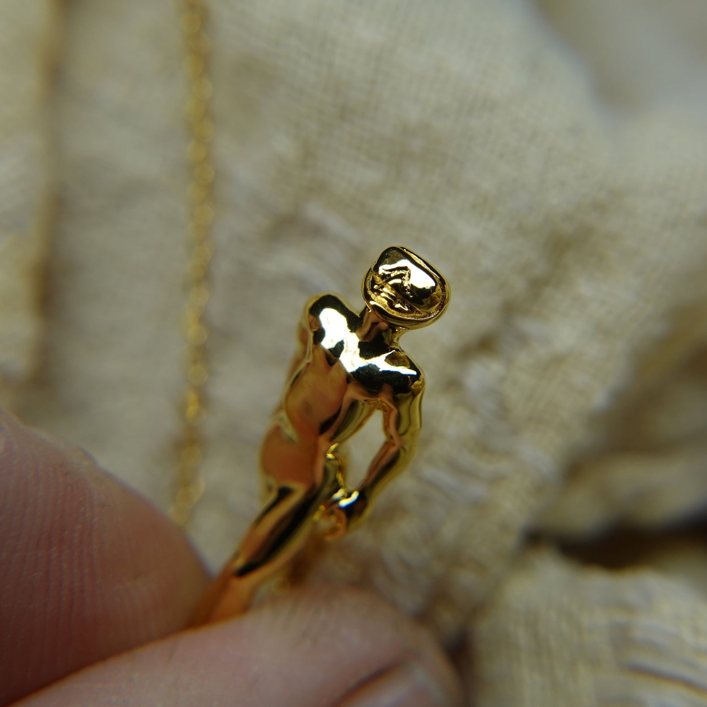 Gold plated silver Freediver pendant and chain. © Adrian Ashley