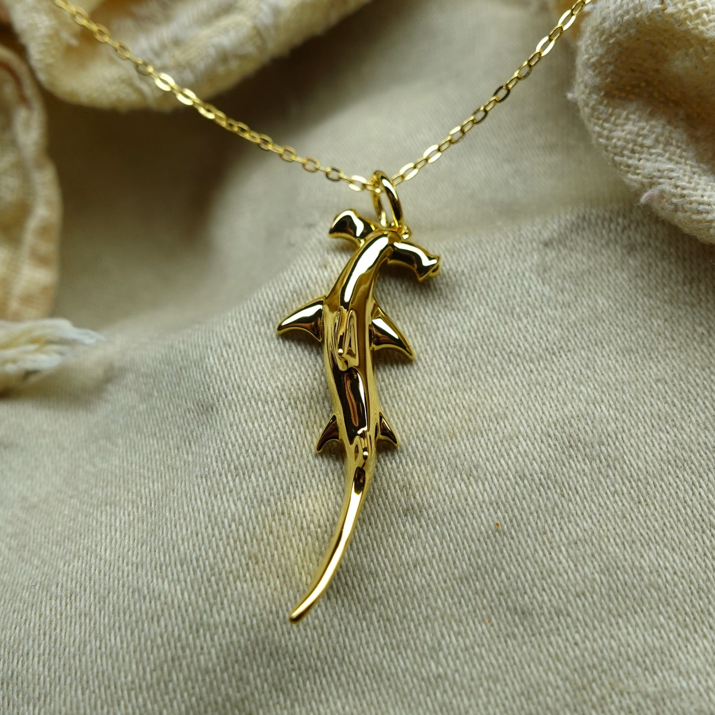 Gold plated silver Hammerhead Shark pendant and chain. © Adrian Ashley