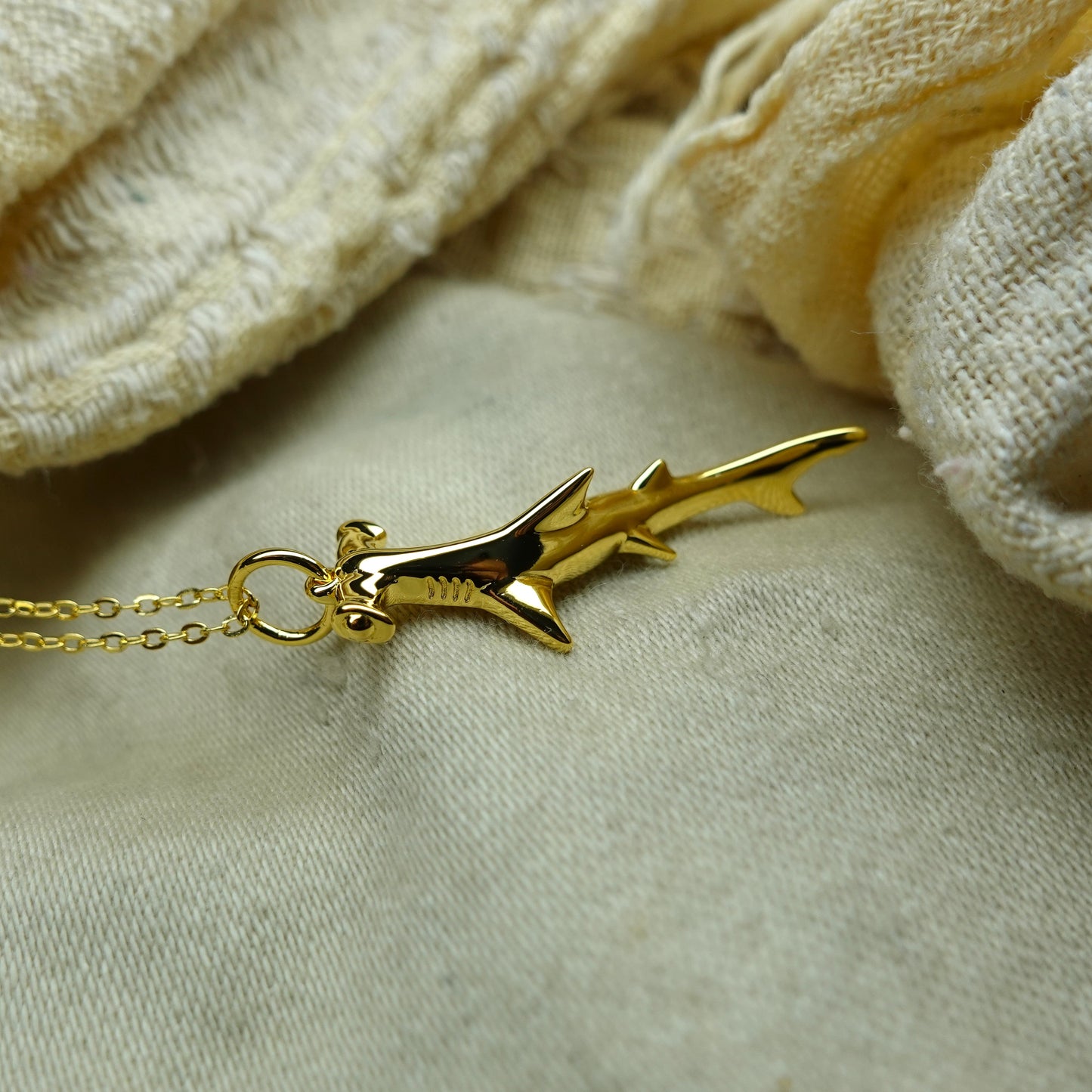 Gold plated silver Hammerhead pendant & cord or chain. © Adrian Ashley