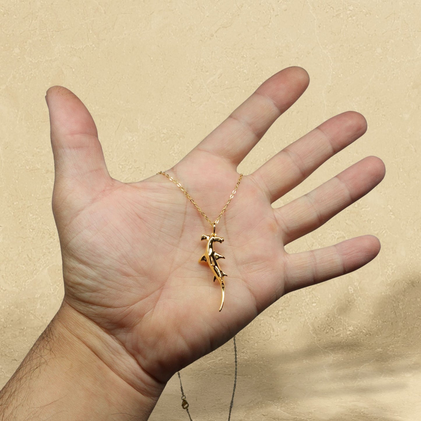 Gold plated silver Hammerhead Shark pendant and chain. © Adrian Ashley