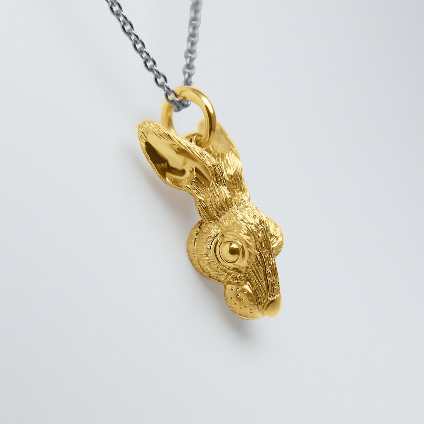 Solid 22ct gold hare pendant and platinum chain.