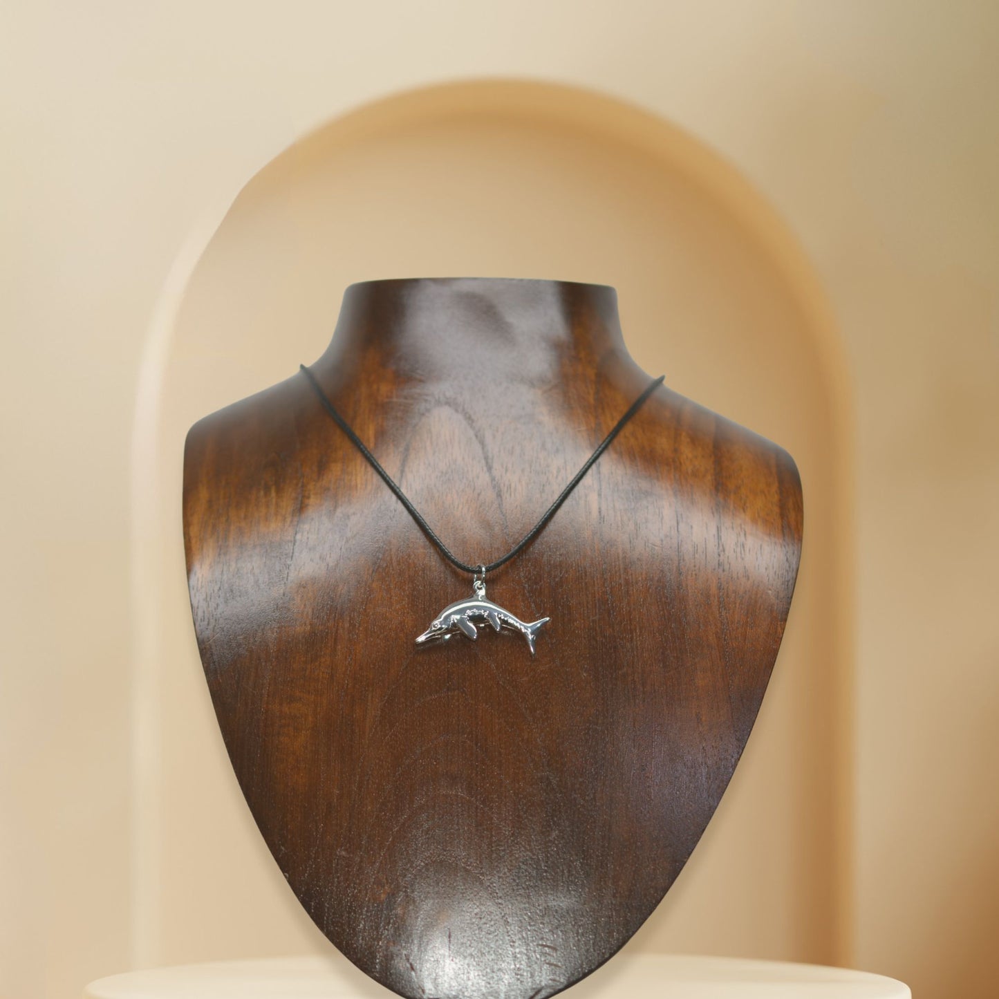 Ichthyosaurus necklace, Made from highly polished, tarnish resistant silver, strung on a strong cord. © Adrian Ashley